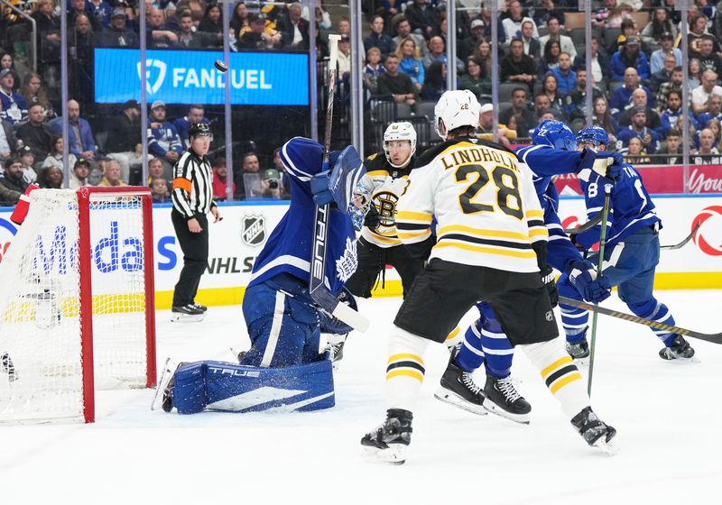 Nov 5, 2024; Toronto, Ontario, CAN; Toronto Maple Leafs goaltender Anthony Stolarz (41) stops a puck as Boston Bruins center Elias Lindholm (28) looks for the rebound during the second period at Scotiabank Arena. Mandatory Credit: Nick Turchiaro-Imagn Imagess