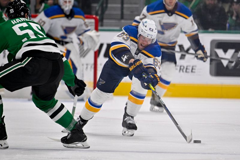 Dec 14, 2024; Dallas, Texas, USA; St. Louis Blues left wing Jake Neighbours (63) passes the puck past Dallas Stars defenseman Thomas Harley (55) during the first period at American Airlines Center. Mandatory Credit: Jerome Miron-Imagn Images