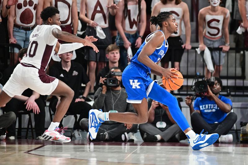 Feb 15, 2023; Starkville, Mississippi, USA; Kentucky Wildcats guard Antonio Reeves (12) handles the ball while defended by Mississippi State Bulldogs guard Dashawn Davis (10) during the first half at Humphrey Coliseum. Mandatory Credit: Matt Bush-USA TODAY Sports