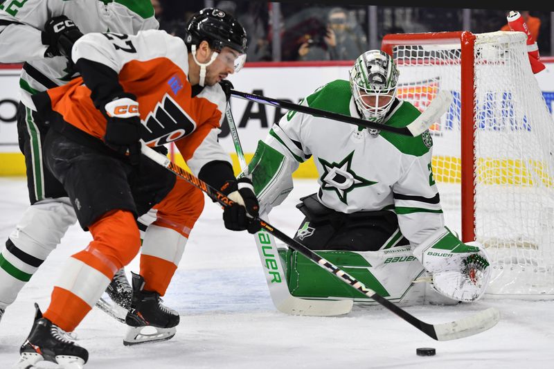 Jan 18, 2024; Philadelphia, Pennsylvania, USA; Philadelphia Flyers left wing Noah Cates (27) battle for the puck against Dallas Stars center Radek Faksa (12) and goaltender Jake Oettinger (29) during the first period at Wells Fargo Center. Mandatory Credit: Eric Hartline-USA TODAY Sports