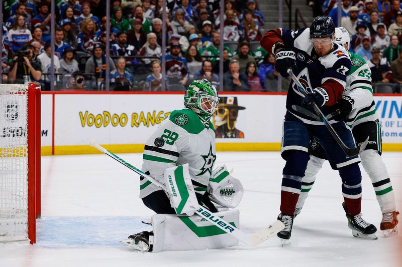 Mar 18, 2026; Denver, Colorado, USA; Dallas Stars goaltender Jake Oettinger (29) deflects a shot as Colorado Avalanche right wing Valeri Nichushkin (13) and center Wyatt Johnston (53) battle for position in the second period at Ball Arena. Mandatory Credit: Isaiah J. Downing-Imagn Images
