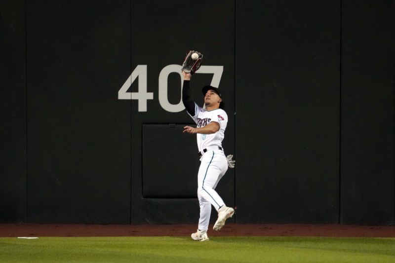 Apr 25, 2023; Phoenix, Arizona, USA; Arizona Diamondbacks center fielder Alek Thomas (5) runs down a fly ball against the Kansas City Royals during the third inning at Chase Field. Mandatory Credit: Joe Camporeale-USA TODAY Sports