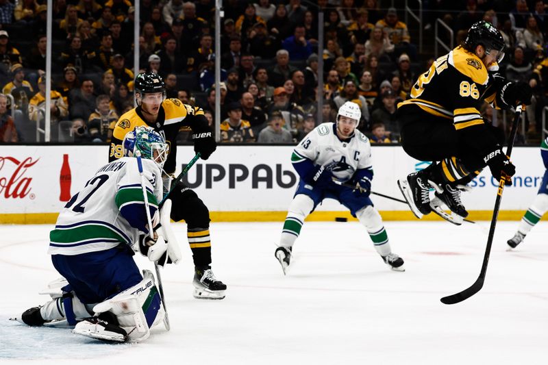 Nov 26, 2024; Boston, Massachusetts, USA; Boston Bruins right wing David Pastrnak (88) leaps in the air as a shot on Vancouver Canucks goaltender Kevin Lankinen (32) goes under him during the third period at TD Garden. Mandatory Credit: Winslow Townson-Imagn Images