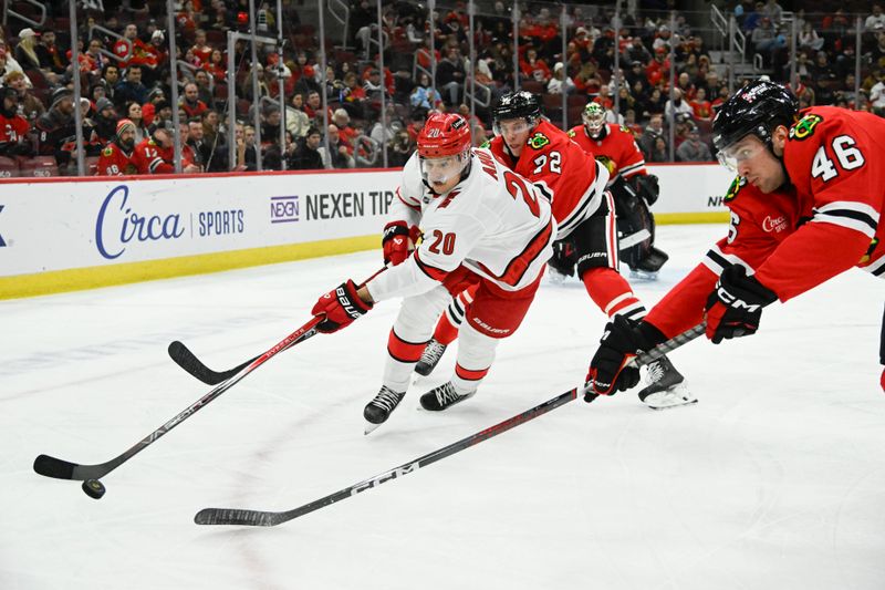 Jan 20, 2025; Chicago, Illinois, USA;  Carolina Hurricanes center Sebastian Aho (20) moves the puck against Chicago Blackhawks defenseman Louis Crevier (46) during the first period at the United Center. Mandatory Credit: Matt Marton-Imagn Images


