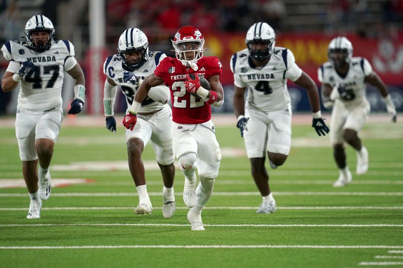 Sep 30, 2023; Fresno, California, USA; Fresno State Bulldogs running back Malik Sherrod (22) runs past Nevada Wolf Pack defensive lineman Hunter Kaupiko (47), linebacker Drue Watts (32), and inebacker Lli'jah Winston (4) in the fourth quarter at Valley Children's Stadium. Mandatory Credit: Cary Edmondson-USA TODAY Sports