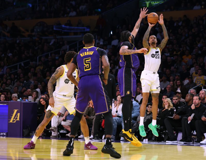 LOS ANGELES, CALIFORNIA - NOVEMBER 19: John Collins #20 of the Utah Jazz scores a three pointer in front of Anthony Davis #3 and Cam Reddish #5 of the Los Angeles Lakers during a 124-118 loss to the Lakers at Crypto.com Arena on November 19, 2024 in Los Angeles, California. (Photo by Harry How/Getty Images) NOTE TO USER: User expressly acknowledges and agrees that, by downloading and or using this photograph, User is consenting to the terms and conditions of the Getty Images License Agreement.  (Photo by Harry How/Getty Images)