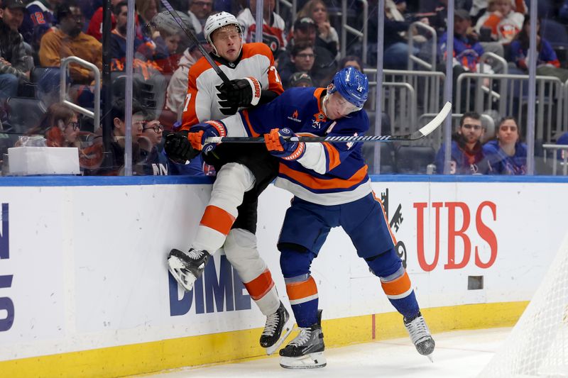 Jan 24, 2025; Elmont, New York, USA; New York Islanders left wing Anders Lee (27) hits Philadelphia Flyers defenseman Erik Johnson (77) during the second period at UBS Arena. Mandatory Credit: Brad Penner-Imagn Images