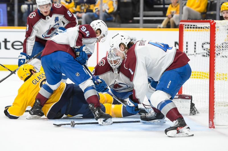 Nov 20, 2023; Nashville, Tennessee, USA; Colorado Avalanche goaltender Alexandar Georgiev (40) blocks the shot of Nashville Predators center Cody Glass (8) during the first period at Bridgestone Arena. Mandatory Credit: Steve Roberts-USA TODAY Sports