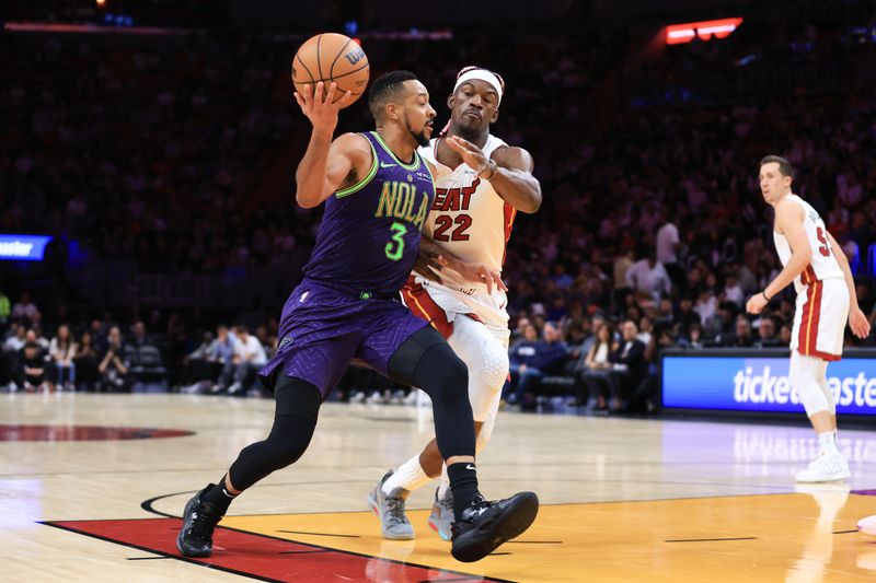 MIAMI, FLORIDA - JANUARY 01: CJ McCollum #3 of the New Orleans Pelicans drives to the basket against Jimmy Butler #22 of the Miami Heat during the third quarter of the game at Kaseya Center on January 01, 2025 in Miami, Florida. NOTE TO USER: User expressly acknowledges and agrees that, by downloading and or using this photograph, User is consenting to the terms and conditions of the Getty Images License Agreement. (Photo by Megan Briggs/Getty Images)