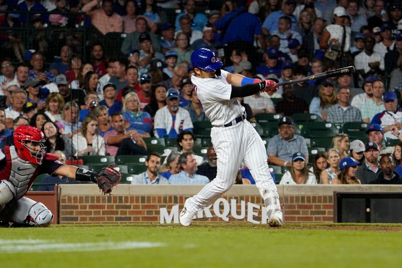 Jul 18, 2023; Chicago, Illinois, USA; Chicago Cubs right fielder Seiya Suzuki (27) hits a home run against the Washington Nationals during the sixth inning at Wrigley Field. Mandatory Credit: David Banks-USA TODAY Sports