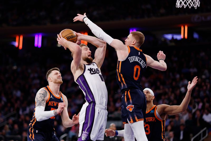 NEW YORK, NEW YORK - APRIL 04: Domantas Sabonis #10 of the Sacramento Kings goes to the basket as Donte DiVincenzo #0 of the New York Knicks defends during the second half at Madison Square Garden on April 04, 2024 in New York City. The Knicks won 120-109. NOTE TO USER: User expressly acknowledges and agrees that, by downloading and/or using this Photograph, user is consenting to the terms and conditions of the Getty Images License Agreement. (Photo by Sarah Stier/Getty Images)