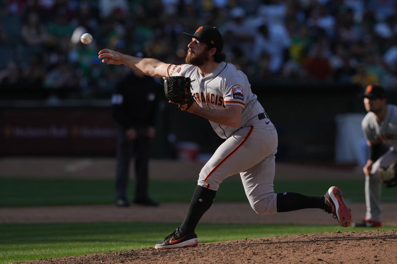 Aug 5, 2023; Oakland, California, USA; San Francisco Giants relief pitcher Ryan Walker (74) throws a pitch against the Oakland Athletics during the eighth inning at Oakland-Alameda County Coliseum. Mandatory Credit: Darren Yamashita-USA TODAY Sports