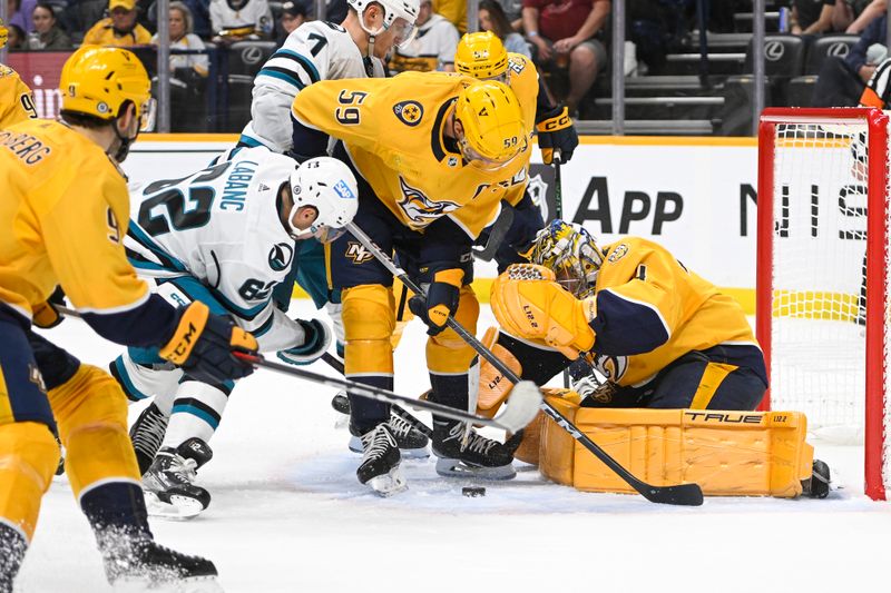 Oct 21, 2023; Nashville, Tennessee, USA; Nashville Predators goaltender Juuse Saros (74) blocks the shot of San Jose Sharks right wing Kevin Labanc (62) during the second period at Bridgestone Arena. Mandatory Credit: Steve Roberts-USA TODAY Sports