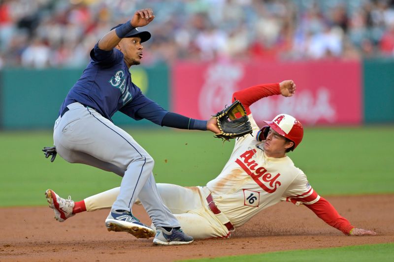 Jul 13, 2024; Anaheim, California, USA;  Mickey Moniak #16 of the Los Angeles Angels beats the throw to Jorge Polanco #7 of the Seattle Mariners for a stolen base in the second inning at Angel Stadium. Mandatory Credit: Jayne Kamin-Oncea-USA TODAY Sports