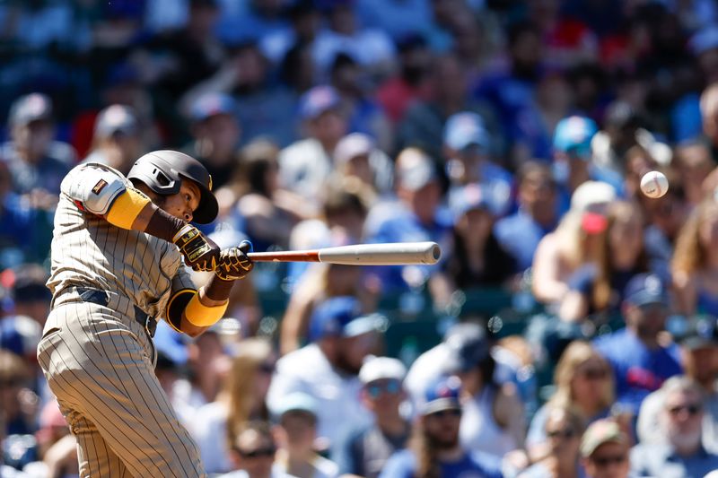 May 8, 2024; Chicago, Illinois, USA; San Diego Padres second base Luis Arraez (4) hits a single against the Chicago Cubs during the fifth inning at Wrigley Field. Mandatory Credit: Kamil Krzaczynski-USA TODAY Sports