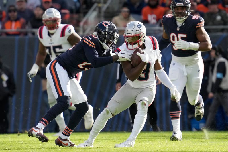 New England Patriots wide receiver Kayshon Boutte (9) carries the ball and is tackled buy Chicago Bears cornerback Tyrique Stevenson during the second half of an NFL football game Sunday, Nov. 10, 2024, in Chicago. (AP Photo/Nam Y. Huh)