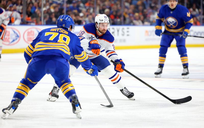 Nov 17, 2025; Buffalo, New York, USA;  Edmonton Oilers left wing Andrew Mangiapane (88) looks to make a pass as Buffalo Sabres defenseman Jacob Bryson (78) defends during the first period at KeyBank Center. Mandatory Credit: Timothy T. Ludwig-Imagn Images