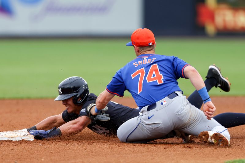 Mar 22, 2024; Tampa, Florida, USA;  New York Yankees shortstop Anthony Volpe (11) steals second base from New York Mets second baseman Zack Short (74) in the fourth inning at George M. Steinbrenner Field. Mandatory Credit: Nathan Ray Seebeck-USA TODAY Sports