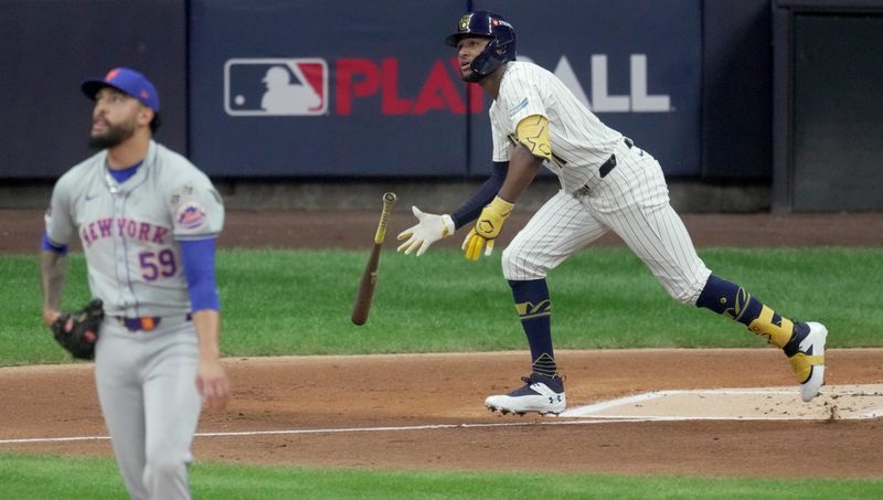 Oct 2, 2024; Milwaukee, Wisconsin, USA; Milwaukee Brewers outfielder Jackson Chourio (11) watches his solo home run off of New York Mets pitcher Sean Manaea (59) during the first inning in game two of their wild-card playoff game at American Family Field. Mandatory Credit: Mark Hoffman-Imagn Images