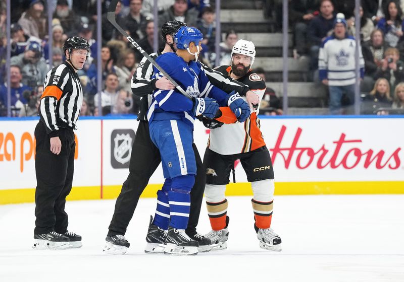 Feb 17, 2024; Toronto, Ontario, CAN; Toronto Maple Leafs right wing Ryan Reaves (75) battles with Anaheim Ducks defenseman Radko Gudas (7) during the second period at Scotiabank Arena. Mandatory Credit: Nick Turchiaro-USA TODAY Sports