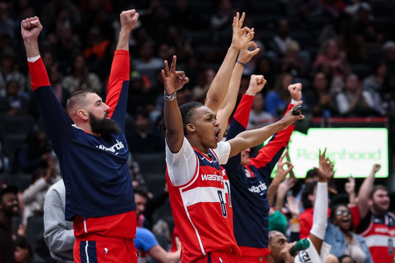 WASHINGTON, DC - JANUARY 01: Carlton Carrington #8 and Jonas Valanciunas #17 of the Washington Wizards celebrate from the bench after a play against the Chicago Bulls during the second half at Capital One Arena on January 1, 2025 in Washington, DC. NOTE TO USER: User expressly acknowledges and agrees that, by downloading and or using this photograph, User is consenting to the terms and conditions of the Getty Images License Agreement. (Photo by Scott Taetsch/Getty Images)