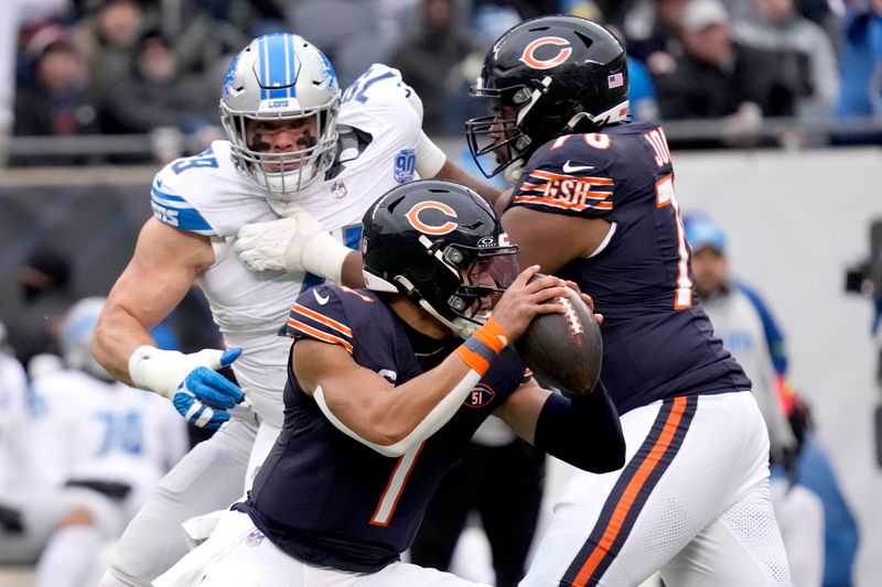 Chicago Bears quarterback Justin Fields steps up in the pocket as offensive tackle Braxton Jones blocks Detroit Lions defensive end John Cominsky during the first half of an NFL football game Sunday, Dec. 10, 2023, in Chicago. (AP Photo/Nam Y. Huh)