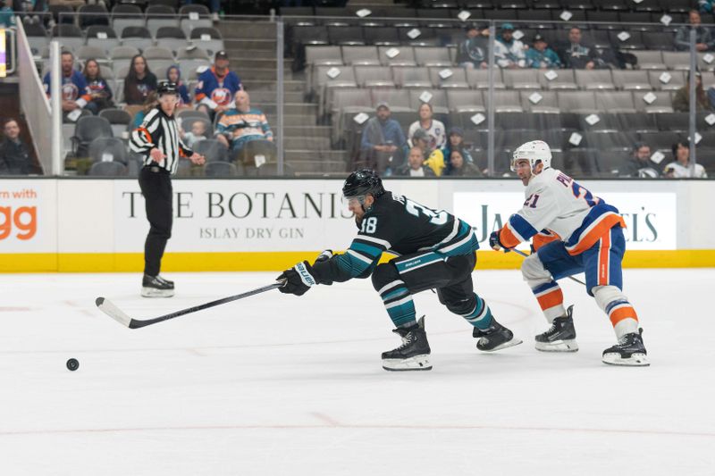 Mar 7, 2024; San Jose, California, USA; San Jose Sharks defenseman Mario Ferraro (38) chases after the puck during the first period against New York Islanders center Kyle Palmieri (21) at SAP Center at San Jose. Mandatory Credit: Stan Szeto-USA TODAY Sports