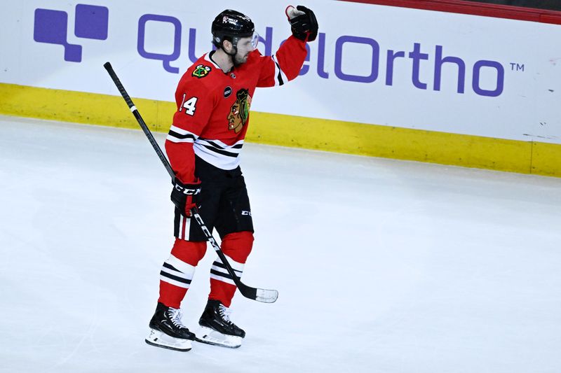 Jan 16, 2024; Chicago, Illinois, USA; Chicago Blackhawks left wing Boris Katchouk (14) pumps his fist after scoring the game winning overtime goal against the San Jose Sharks during the third period at United Center. Mandatory Credit: Matt Marton-USA TODAY Sports