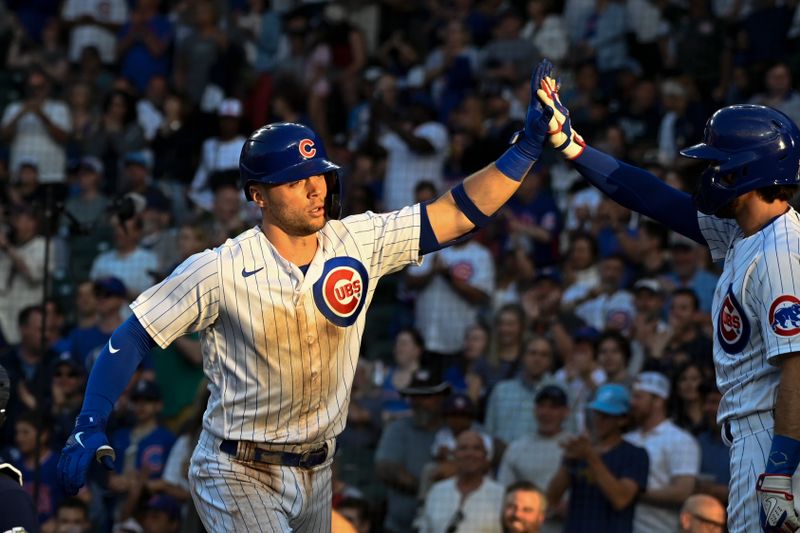 May 30, 2023; Chicago, Illinois, USA;  Chicago Cubs second baseman Nico Hoerner (2), left, high-fives shortstop Dansby Swanson (7) after hitting a home run against the Tampa Bay Rays during the first inning at Wrigley Field. Mandatory Credit: Matt Marton-USA TODAY Sports