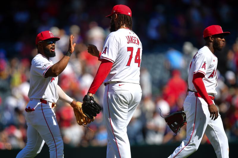Apr 6, 2025; Anaheim, California, USA; Los Angeles Angels third baseman Luis Rengifo (2) and pitcher Kenley Jansen (74) celebrate the victory against the Cleveland Guardians  at Angel Stadium. Mandatory Credit: Gary A. Vasquez-Imagn Images
