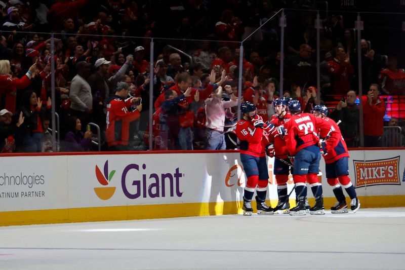 Oct 17, 2024; Washington, District of Columbia, USA; Washington Capitals right wing Taylor Raddysh (16) celebrates with teammates after scoring a goal against the Dallas Stars in the second period at Capital One Arena. Mandatory Credit: Geoff Burke-Imagn Images