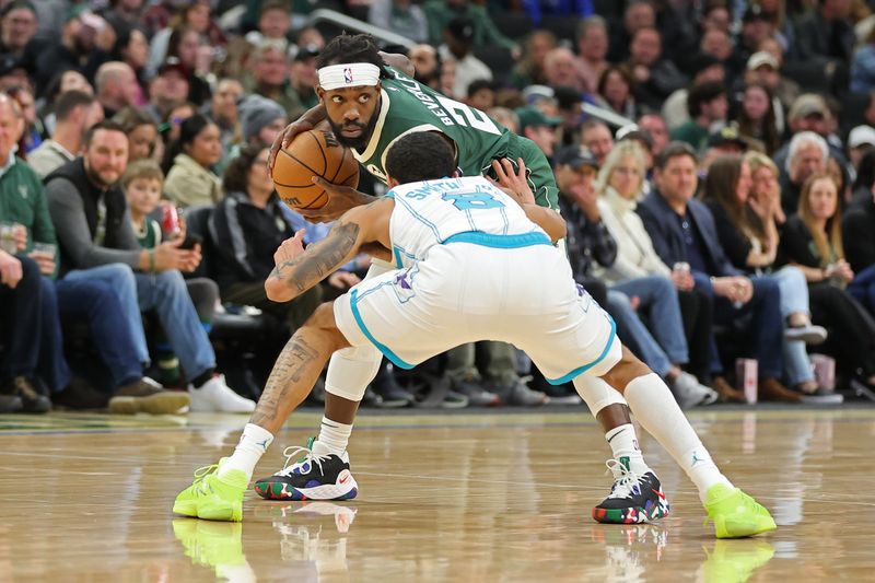 MILWAUKEE, WISCONSIN - FEBRUARY 09: Patrick Beverley #22 of the Milwaukee Bucks is defended by Nick Smith Jr. #8 of the Charlotte Hornets during a game at Fiserv Forum on February 09, 2024 in Milwaukee, Wisconsin. NOTE TO USER: User expressly acknowledges and agrees that, by downloading and or using this photograph, User is consenting to the terms and conditions of the Getty Images License Agreement. (Photo by Stacy Revere/Getty Images)