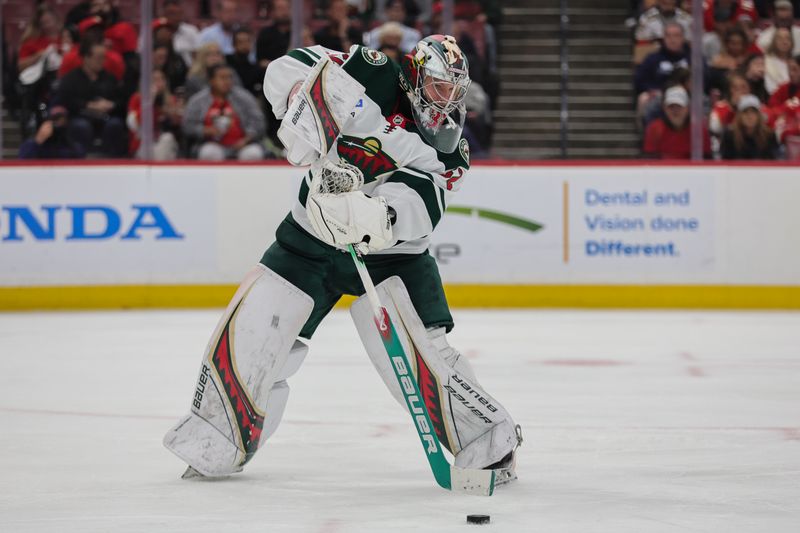 Oct 22, 2024; Sunrise, Florida, USA; Minnesota Wild goaltender Filip Gustavsson (32) passes the puck against the Florida Panthers during the second period at Amerant Bank Arena. Mandatory Credit: Sam Navarro-Imagn Images