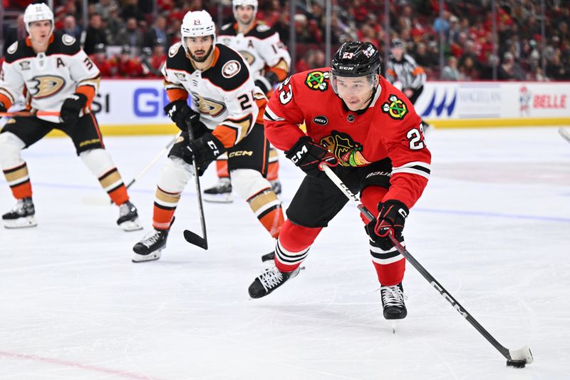 Dec 7, 2023; Chicago, Illinois, USA; Chicago Blackhawks forward Philipp Kurashev (23) skates the puck up the ice in the third period against the Anaheim Ducks at United Center. Mandatory Credit: Jamie Sabau-USA TODAY Sports