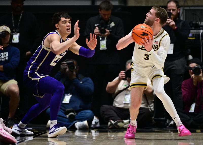 Jan 7, 2026; West Lafayette, Indiana, USA; Purdue Boilermakers guard Braden Smith (3) looks at the basket over Washington Huskies guard J.J. Mandaquit (23) during the first half at Mackey Arena. Mandatory Credit: Marc Lebryk-Imagn Images