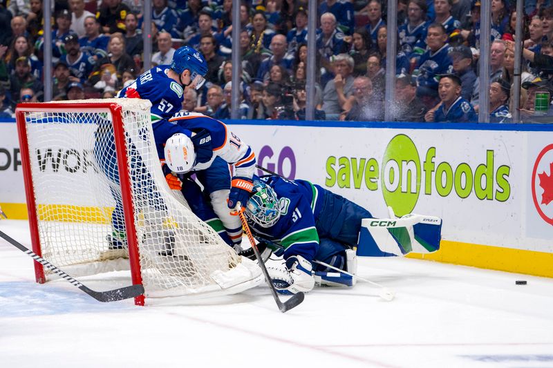 May 10, 2024; Vancouver, British Columbia, CAN; Vancouver Canucks defenseman Tyler Myers (57) and goalie Arturs Silvos (31) battle with Edmonton Oilers forward Zach Hyman (18) during the second period in game two of the second round of the 2024 Stanley Cup Playoffs at Rogers Arena. Mandatory Credit: Bob Frid-USA TODAY Sports