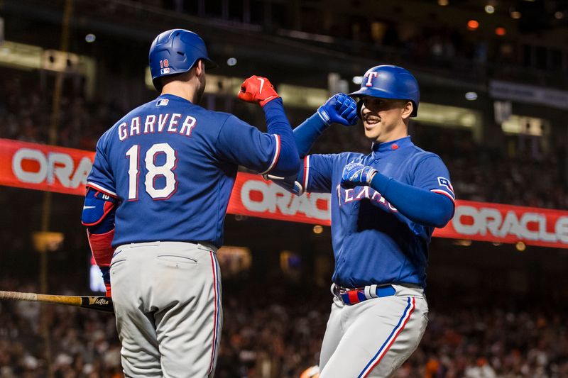 Aug 11, 2023; San Francisco, California, USA; Texas Rangers first baseman Nathaniel Lowe (right) is congratulated by catcher Mitch Garver (18) after hitingt a solo home run against the San Francisco Giants during the sixth inning at Oracle Park. Mandatory Credit: John Hefti-USA TODAY Sports