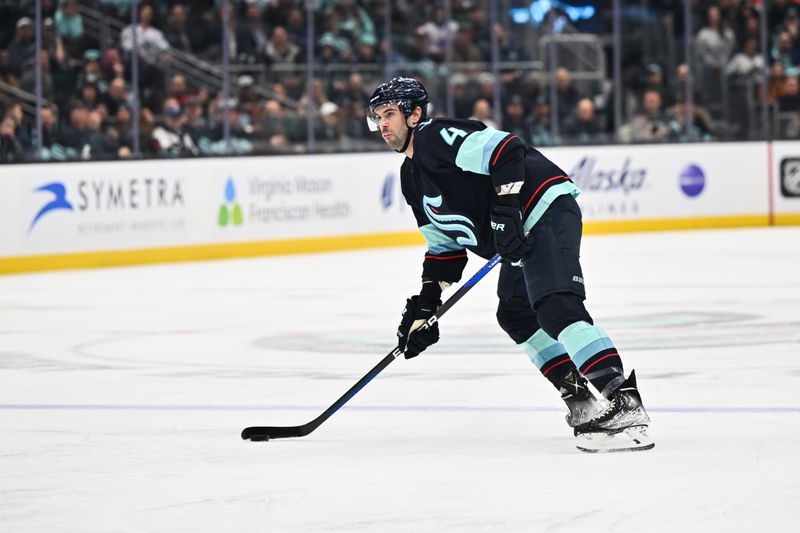 Feb 16, 2023; Seattle, Washington, USA; Seattle Kraken defenseman Justin Schultz (4) looks to pass the puck against the Philadelphia Flyers during the first period at Climate Pledge Arena. Mandatory Credit: Steven Bisig-USA TODAY Sports