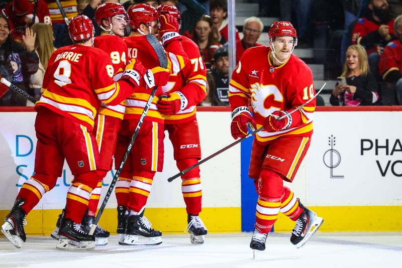 Nov 11, 2024; Calgary, Alberta, CAN; Calgary Flames center Jonathan Huberdeau (10) celebrates his goal with teammates against the Los Angeles Kings during the second period at Scotiabank Saddledome. Mandatory Credit: Sergei Belski-Imagn Images