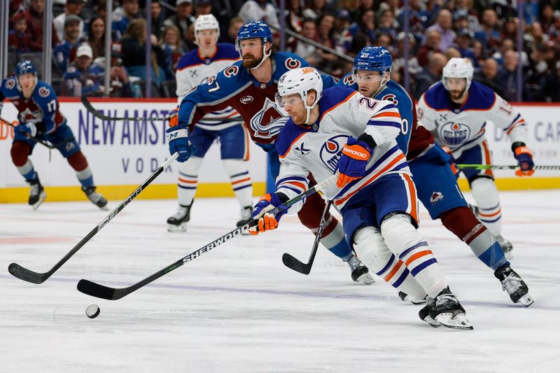 Jan 16, 2025; Denver, Colorado, USA; Edmonton Oilers right wing Connor Brown (28) controls the puck ahead of Colorado Avalanche center Ross Colton (20) in the first period at Ball Arena. Mandatory Credit: Isaiah J. Downing-Imagn Images