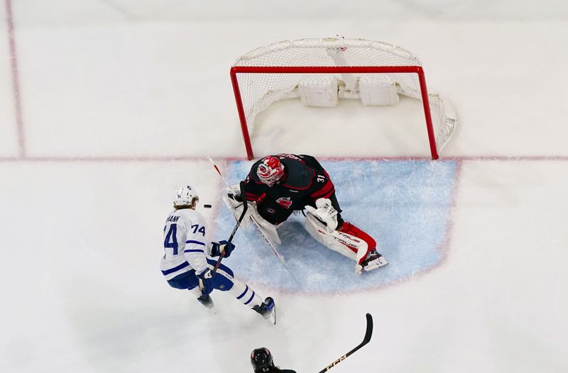 Mar 24, 2024; Raleigh, North Carolina, USA;  Carolina Hurricanes goaltender Frederik Andersen (31) stops the shot attempt by Toronto Maple Leafs center Bobby McMann (74) during the third period at PNC Arena. Mandatory Credit: James Guillory-USA TODAY Sports