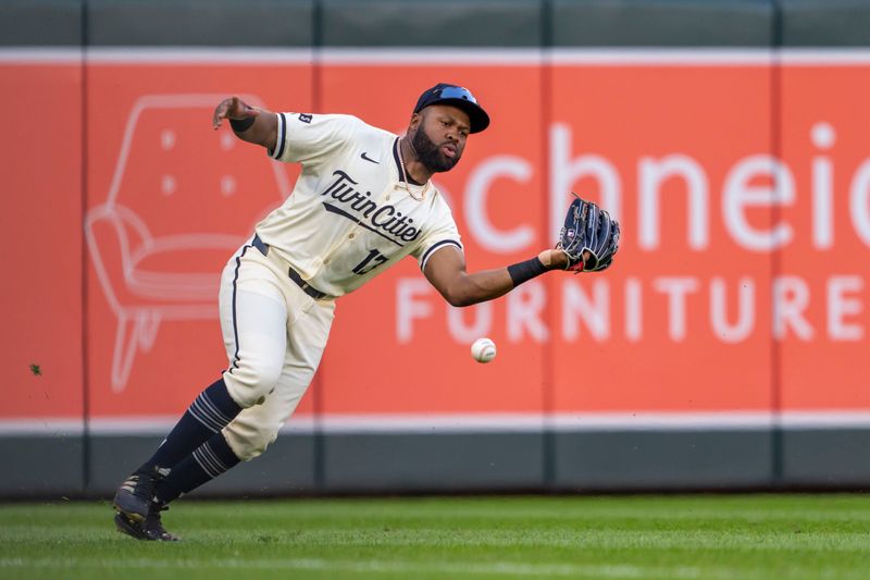 Jun 11, 2024; Minneapolis, Minnesota, USA; Minnesota Twins left fielder Manuel Margot (13) attempts to catch a fly ball against the Colorado Rockies in the fifth inning at Target Field. Mandatory Credit: Jesse Johnson-USA TODAY Sports
