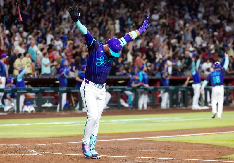 May 9, 2025; Phoenix, Arizona, USA; Arizona Diamondbacks outfielder Lourdes Gurriel Jr. celebrates after hitting a grand slam home run in the fifth inning against the Los Angeles Dodgers at Chase Field. Mandatory Credit: Mark J. Rebilas-Imagn Images