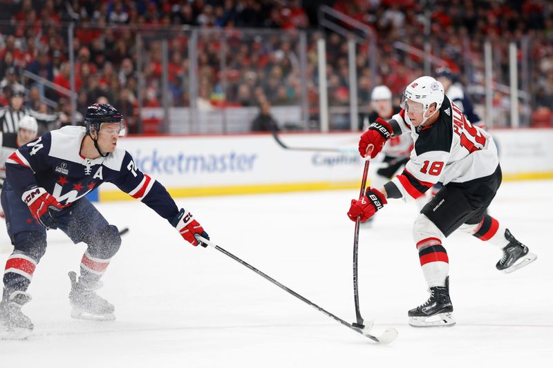 Feb 20, 2024; Washington, District of Columbia, USA; New Jersey Devils left wing Ondrej Palat (18) shoots the puck as Washington Capitals defenseman John Carlson (74) defends in the first period at Capital One Arena. Mandatory Credit: Geoff Burke-USA TODAY Sports