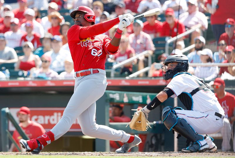 Feb 26, 2023; Jupiter, Florida, USA; St. Louis Cardinals left fielder Jordan Walker (67) hits a home run in the first inning against the Miami Marlins at Roger Dean Stadium. Mandatory Credit: Rhona Wise-USA TODAY Sports