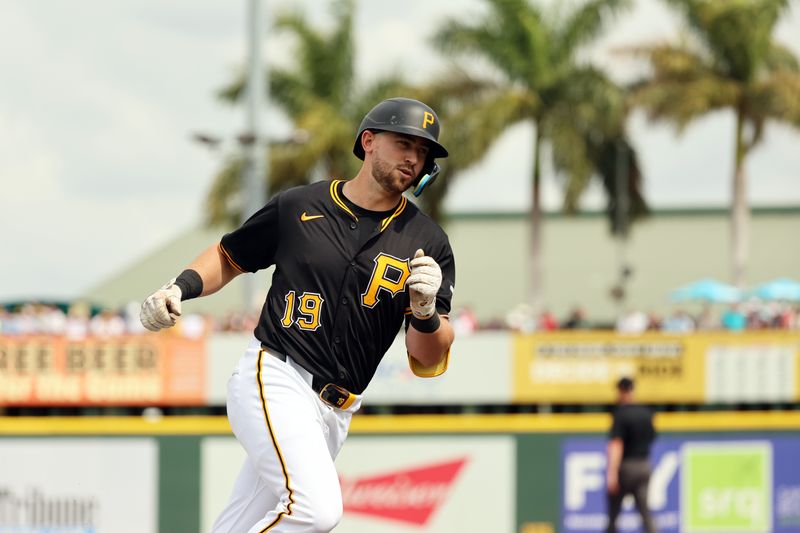 Mar 1, 2024; Bradenton, Florida, USA;  Pittsburgh Pirates third baseman Jared Triolo (19) hits a 3-run home run during the second inning against the Tampa Bay Rays at LECOM Park. Mandatory Credit: Kim Klement Neitzel-USA TODAY Sports