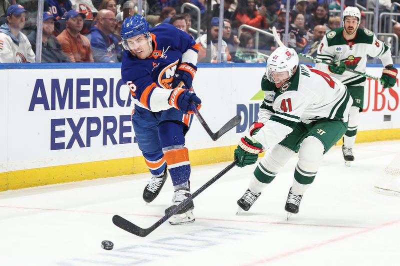 Apr 4, 2025; Elmont, New York, USA;  New York Islanders defenseman Ryan Pulock (6) and Minnesota Wild center Gustav Nyquist (41) battle for control of the puck in the first period at UBS Arena. Mandatory Credit: Wendell Cruz-Imagn Images