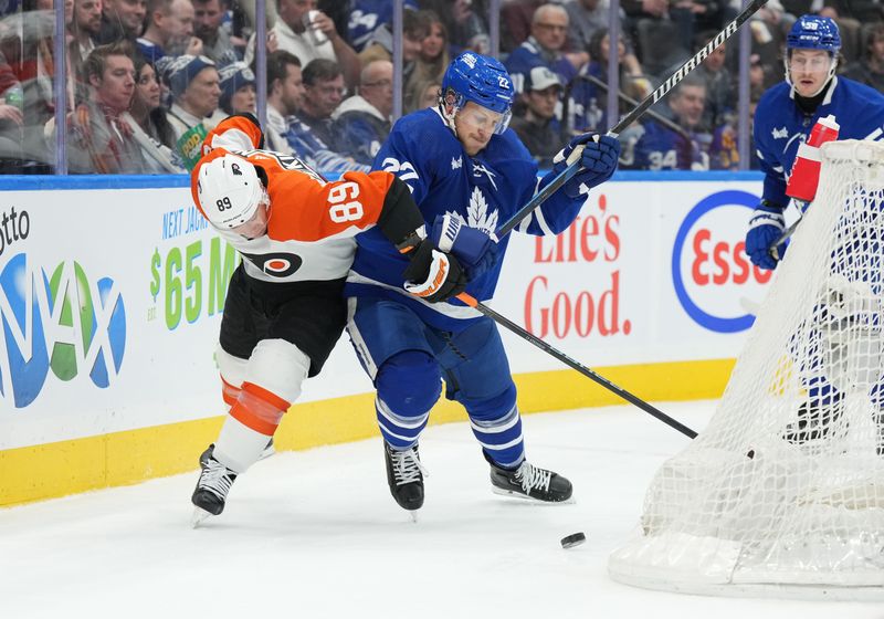 Feb 15, 2024; Toronto, Ontario, CAN; Philadelphia Flyers right wing Cam Atkinson (89) battles for the puck with Toronto Maple Leafs defenseman Jake McCabe (22) during the second period at Scotiabank Arena. Mandatory Credit: Nick Turchiaro-USA TODAY Sports