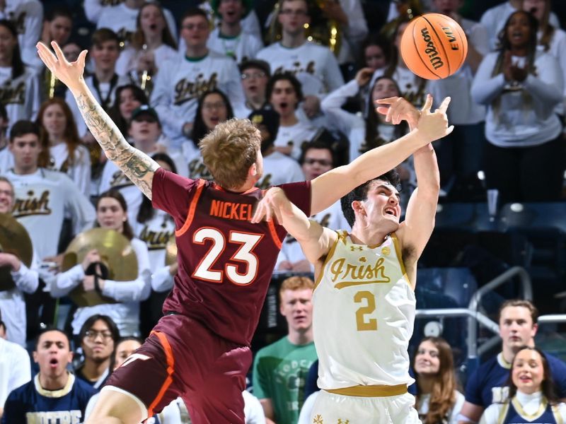 Feb 10, 2024; South Bend, Indiana, USA; Virginia Tech Hokies guard Tyler Nickel (23) and Notre Dame Fighting Irish guard Logan Imes (2) reach for a loose ball in the second half at the Purcell Pavilion. Mandatory Credit: Matt Cashore-USA TODAY Sports