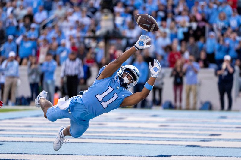 Nov 25, 2022; Chapel Hill, North Carolina, USA; North Carolina Tar Heels wide receiver Josh Downs (11) attempts to catch the ball in the first quarter at Kenan Memorial Stadium. Mandatory Credit: Bob Donnan-USA TODAY Sports